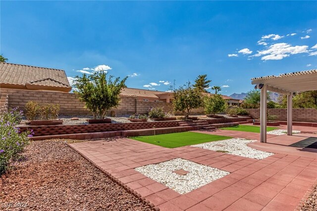 8705 Villa Ridge Dr, Las Vegas, NV 89134 - fenced backyard with a pergola, a patio, and a putting green