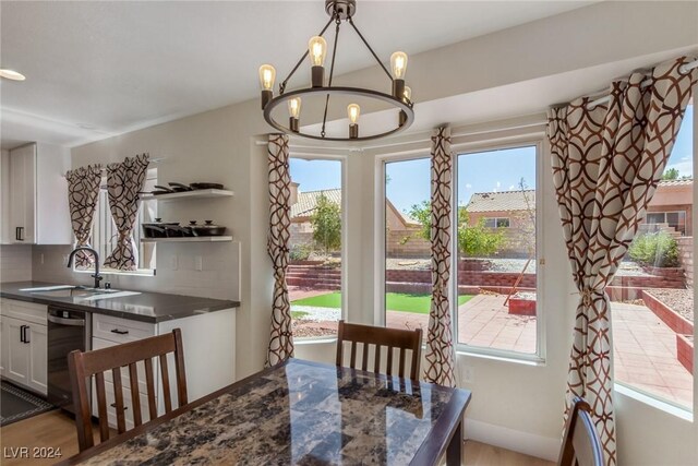 8705 Villa Ridge Dr, Las Vegas, NV 89134 - dining room with a chandelier, healthy amount of natural light, and wood finished floors