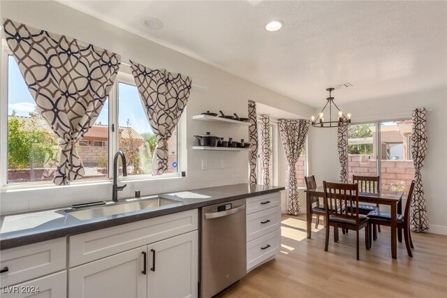 8705 Villa Ridge Dr, Las Vegas, NV 89134 - kitchen with stainless steel dishwasher, open shelves, a chandelier, dark countertops, and recessed lighting