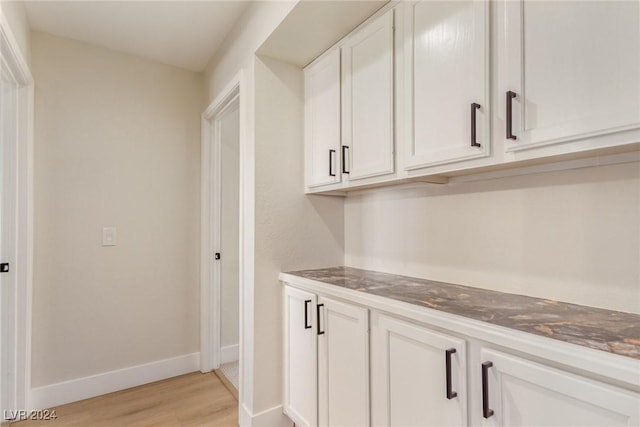 interior space featuring white cabinetry and light wood-type flooring