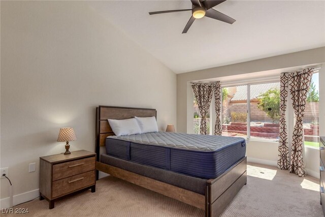 8705 Villa Ridge Dr, Las Vegas, NV 89134 - bedroom with light carpet, vaulted ceiling, and a ceiling fan