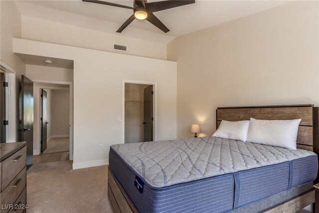 8705 Villa Ridge Dr, Las Vegas, NV 89134 - carpeted bedroom with a ceiling fan and a walk in closet