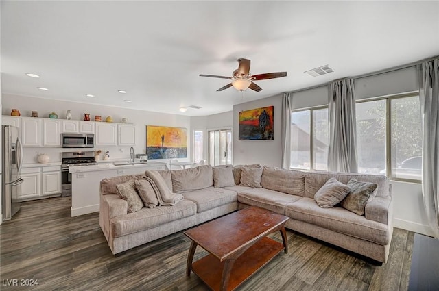 living room featuring dark hardwood / wood-style flooring, ceiling fan, a healthy amount of sunlight, and sink