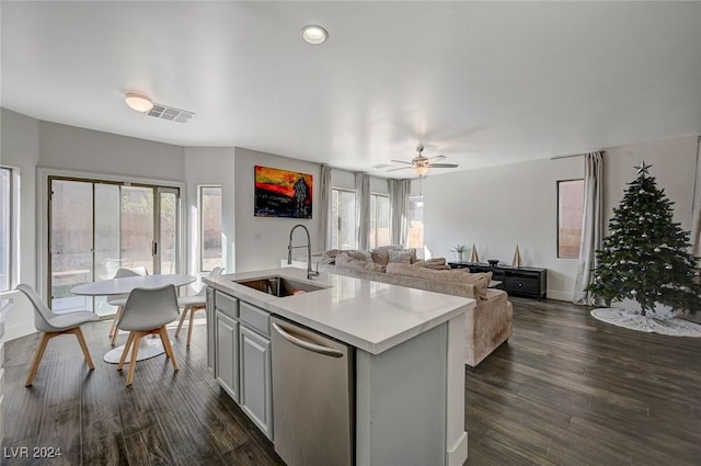 kitchen featuring ceiling fan, a kitchen island with sink, sink, dishwasher, and dark hardwood / wood-style floors