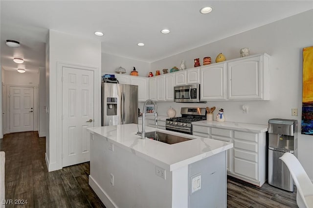 kitchen with sink, stainless steel appliances, dark hardwood / wood-style flooring, a kitchen island with sink, and white cabinets