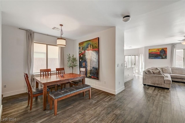 dining area featuring ceiling fan and dark wood-type flooring