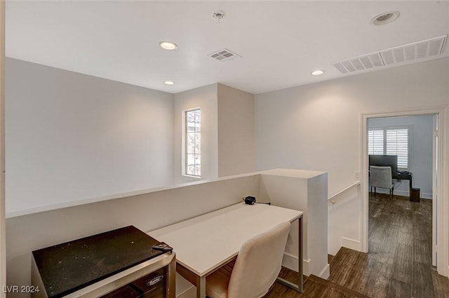 home office with dark hardwood / wood-style flooring