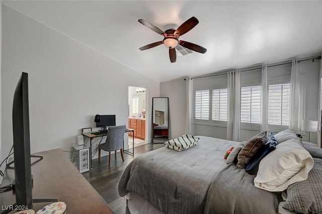 bedroom with dark hardwood / wood-style flooring, vaulted ceiling, and ceiling fan