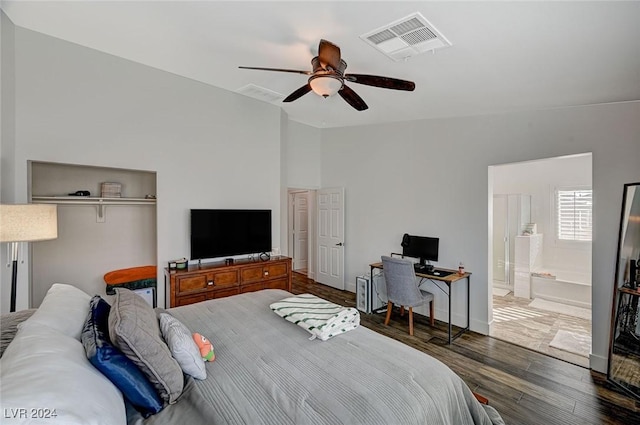 bedroom featuring connected bathroom, ceiling fan, dark hardwood / wood-style flooring, vaulted ceiling, and a closet