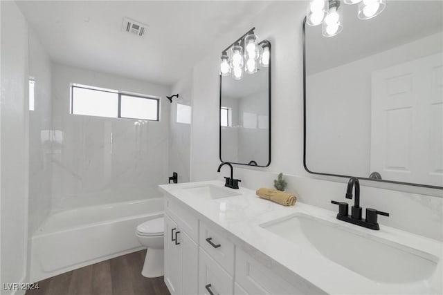 full bathroom with hardwood / wood-style flooring, toilet, shower / tub combination, and vanity