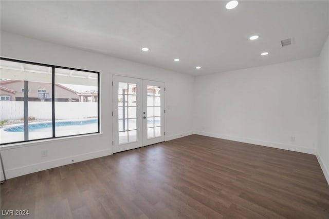 spare room with dark hardwood / wood-style flooring and french doors