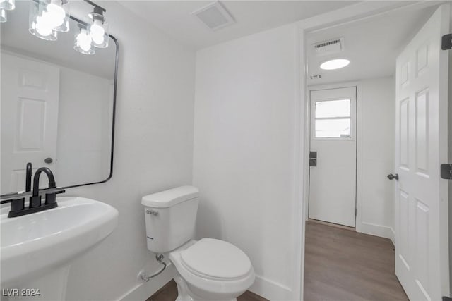 bathroom featuring sink, hardwood / wood-style floors, and toilet