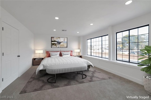 carpeted bedroom featuring multiple windows