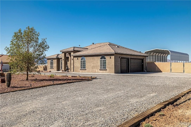 ranch-style home with a carport and a garage