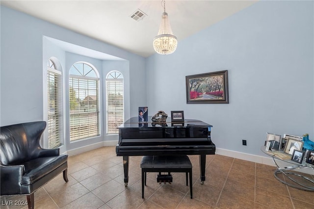 miscellaneous room with tile patterned floors and an inviting chandelier