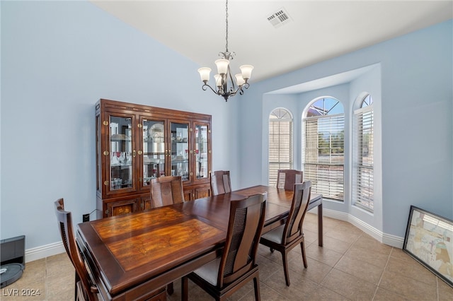 dining area featuring light tile patterned floors and a chandelier