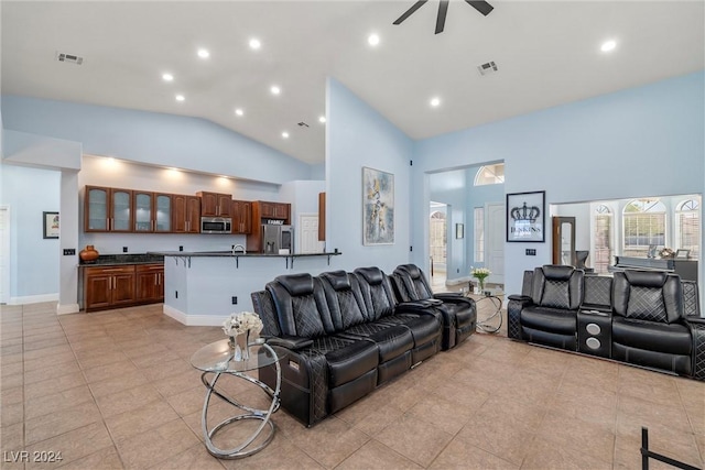 tiled living room featuring high vaulted ceiling and ceiling fan