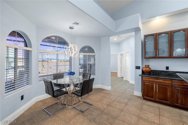 dining room with an inviting chandelier and light tile patterned floors