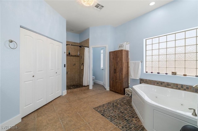 bathroom featuring separate shower and tub, tile patterned floors, and toilet