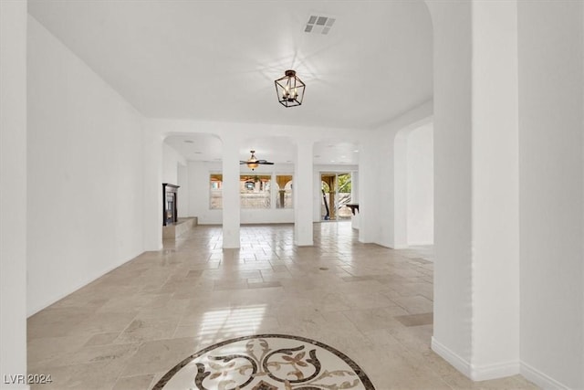 interior space with decorative columns and ceiling fan