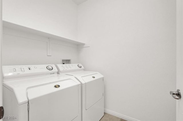 clothes washing area featuring separate washer and dryer