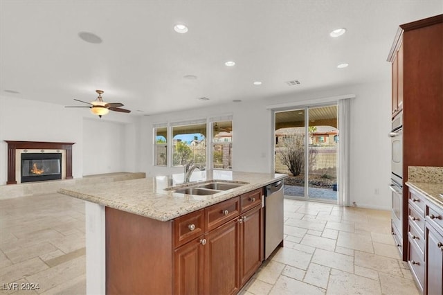 kitchen featuring plenty of natural light, dishwasher, sink, and an island with sink