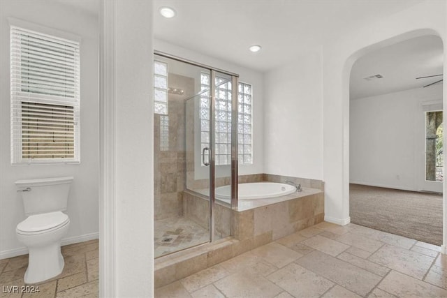 bathroom with toilet, ceiling fan, and independent shower and bath