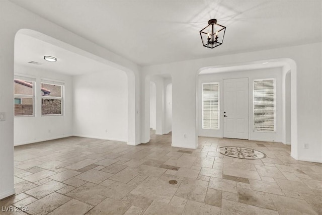 entrance foyer featuring a chandelier