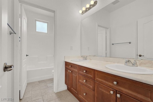 full bathroom with vanity, tub / shower combination, and toilet