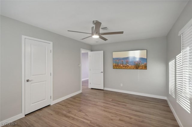 unfurnished bedroom with light hardwood / wood-style flooring and ceiling fan