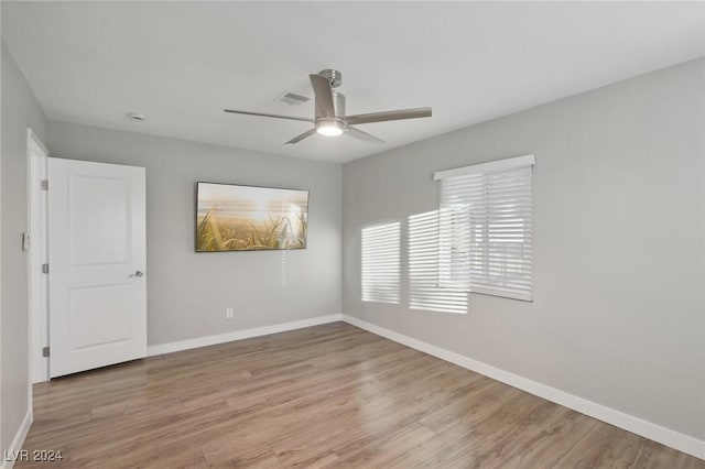 empty room featuring ceiling fan and light hardwood / wood-style floors