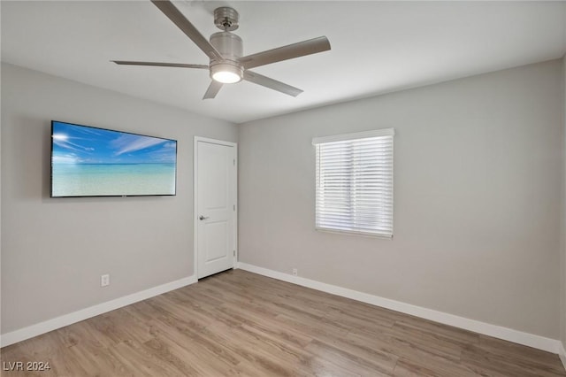 empty room with light wood-type flooring and ceiling fan