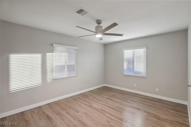 empty room featuring light hardwood / wood-style flooring and ceiling fan