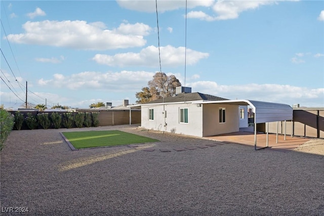 rear view of property with a carport and cooling unit