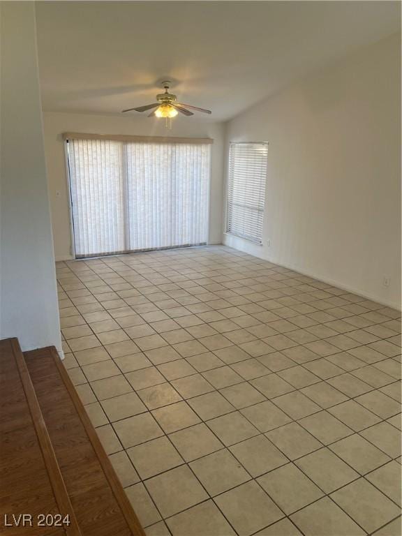 spare room featuring ceiling fan and light tile patterned flooring