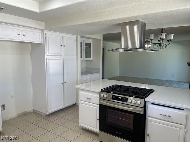 kitchen featuring light tile patterned floors, white cabinets, light countertops, stainless steel range with gas cooktop, and island exhaust hood