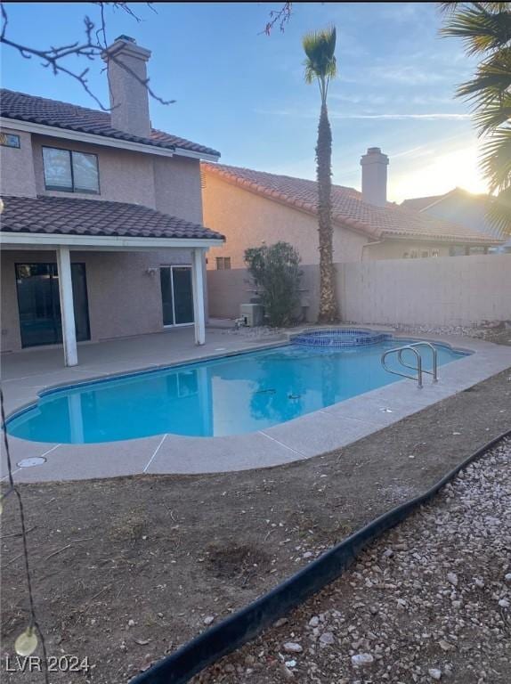 view of swimming pool featuring a patio area, a fenced backyard, and a fenced in pool