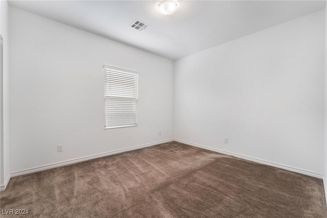 empty room featuring dark colored carpet