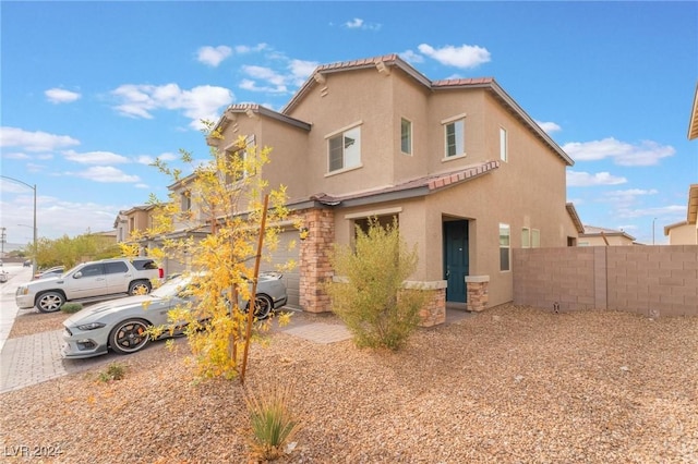 rear view of property with a garage