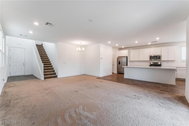 unfurnished living room with light colored carpet and an inviting chandelier