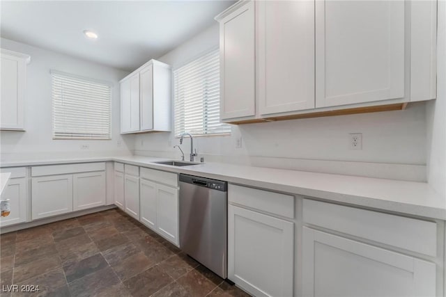 kitchen with dishwasher, white cabinetry, and sink