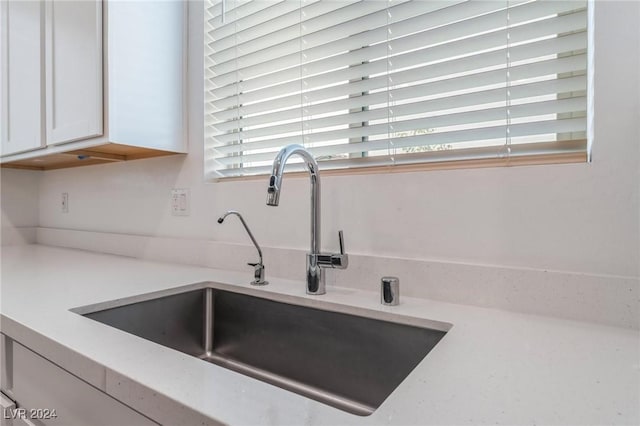 interior details with sink and white cabinets