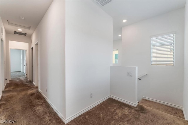 corridor with dark colored carpet