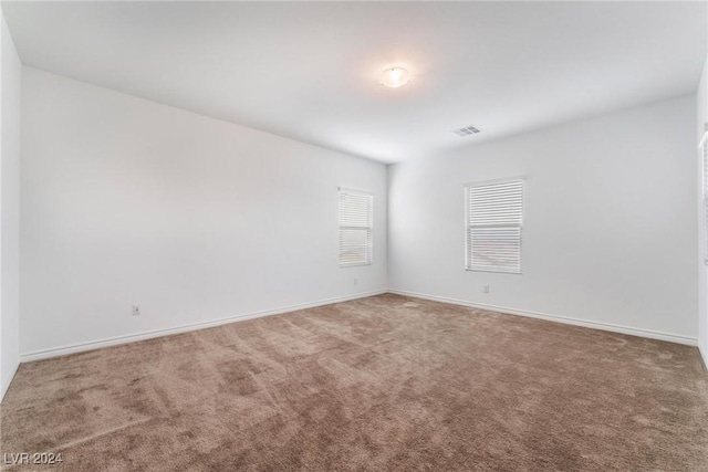 unfurnished room with carpet flooring