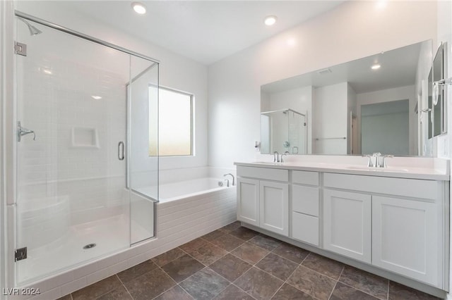 bathroom with vanity and independent shower and bath