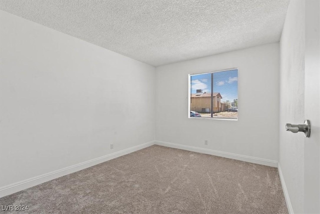 spare room with carpet floors and a textured ceiling