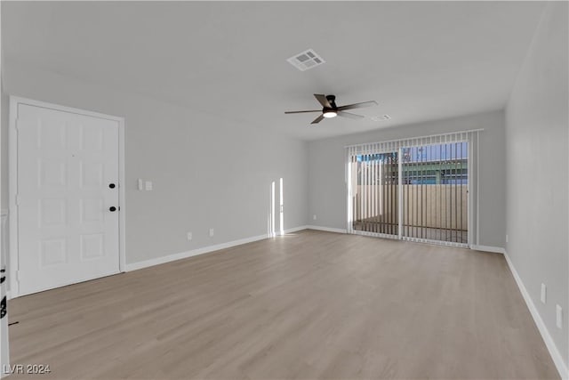 spare room with ceiling fan and light wood-type flooring