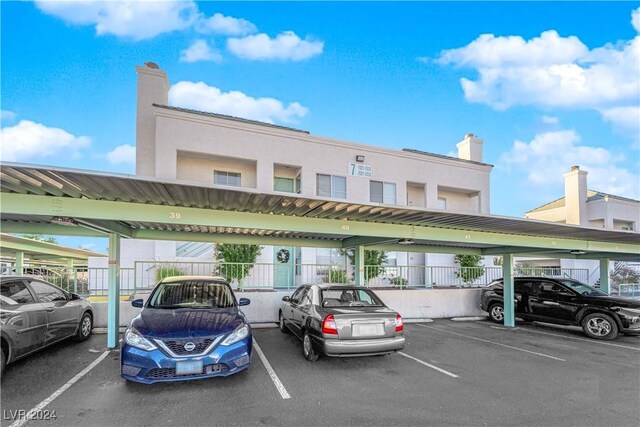 view of parking / parking lot featuring a carport