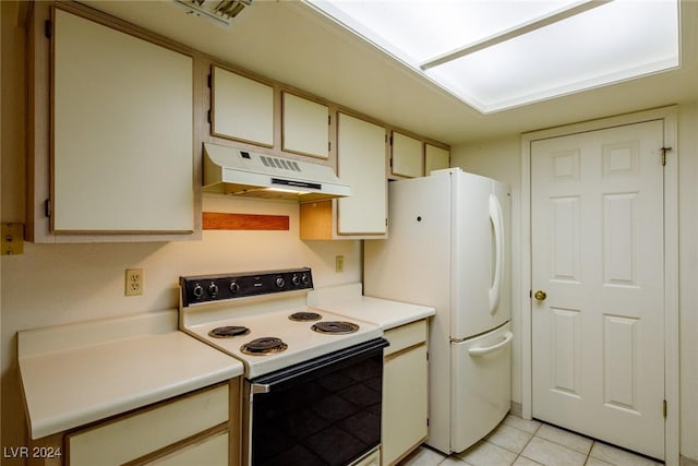 kitchen featuring light tile patterned floors, white appliances, and cream cabinetry