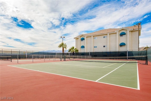 view of tennis court featuring basketball court